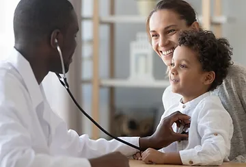 A doctor is examining a child with a stethoscope.