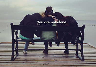 Three people sitting on a bench with the words " you are not alone ".