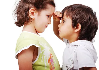 A boy and girl are looking at each other.