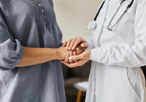 Two doctors holding hands in a room.
